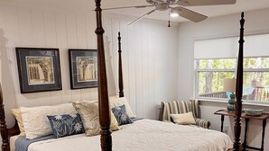 A four-poster bed with a ceiling fan, framed artwork on the wall, and a view of the outdoors through a window. - Pollys Place for bird lovers - Private, Close to Gallatin-Sleeps 10-Pet Friendly (Portland)