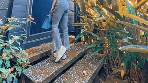 A person standing on outdoor steps in front of a modern building with a large window and a door. - Dragonfly Hotel Nghia Lo - Free Sauna & Onsen (Nghia Lo)