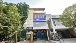 A hotel with a sign for 'Aroma Inn' and 'Fab Hotels' on the facade. - FabHotel Kavya Inn (Faridabad)