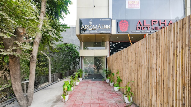 A building with a sign for Aromainn and Alpha Detail. - FabHotel Kavya Inn (Faridabad)