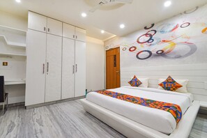A modern bedroom with a large bed, a wardrobe, and a desk. - Fabhotel De Alphabet Ii (Hyderabad)