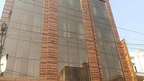 A building with large windows and a brick facade. - Fabhotel Sky Heights (Haridwar)