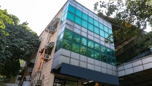 A modern building with a glass facade and a flat roof. - FabHotel Comfort Residency II (Gurugram)