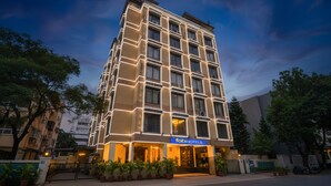 A multi-story hotel with a modern facade, featuring a prominent 'fabHOTELS' sign at the entrance. - FabHotel Olive Suite (Pune)