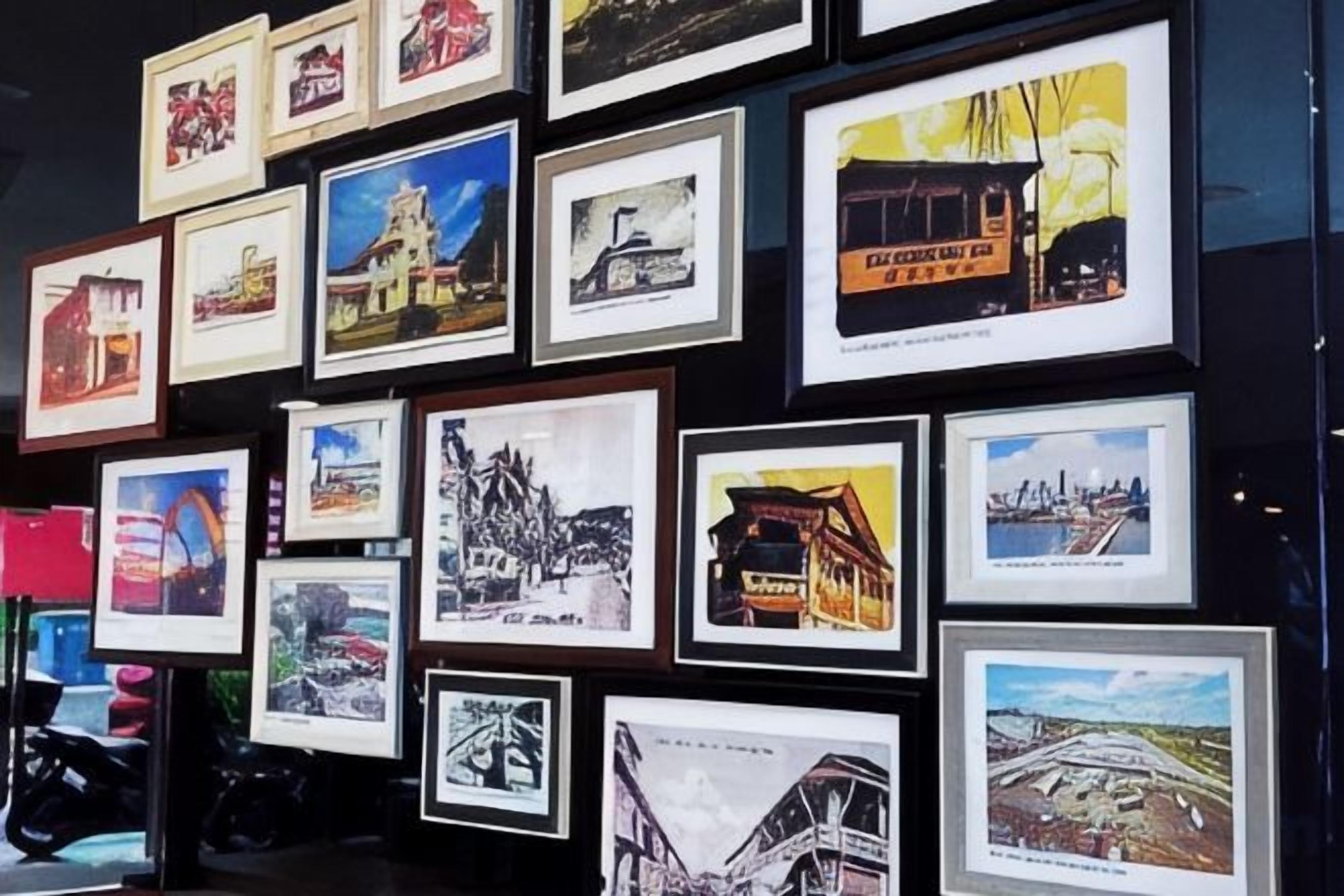 A wall of framed photographs depicting various buildings and landmarks.