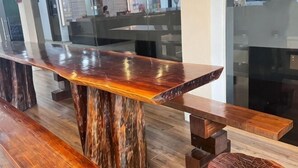 A bar area with a polished wooden counter and benches. - Chariton Hotel Skudai Kiri (Johor Bahru)
