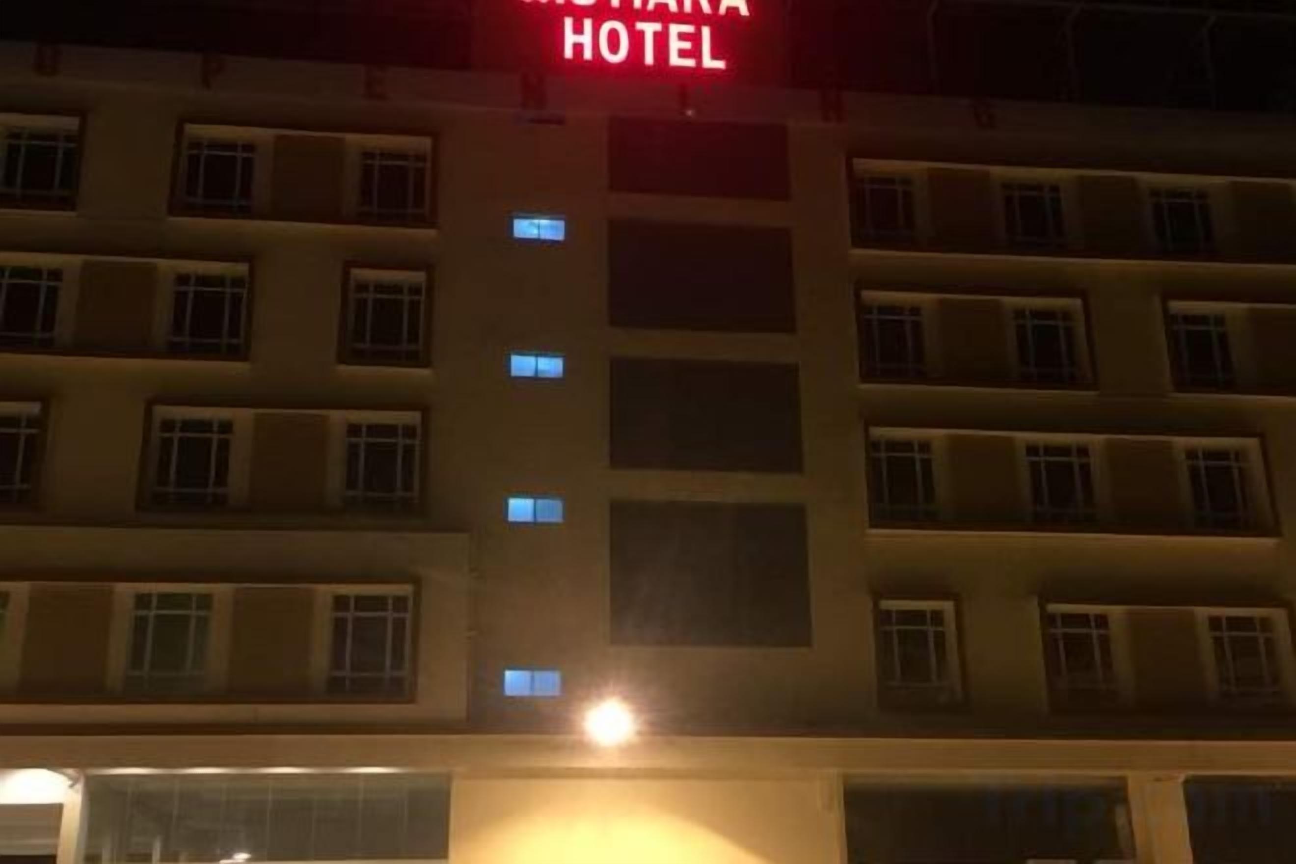 A multi-story hotel building with a prominent sign indicating it is a hotel.