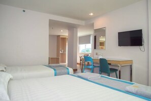 A hotel room with two beds, a desk, a chair, a TV, and a window. - TD Mutiara Hotel (Semporna)