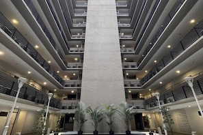 A multi-level atrium with a central column, balconies, and indoor plants. - Nick's Homestay @ Boulevard Mall @ Imperial Suites Kuching (Kuching)