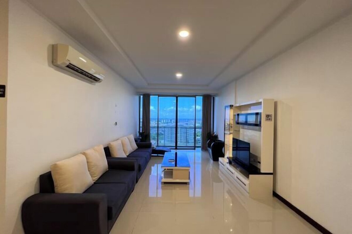 A modern living room with a sofa, a coffee table, and a TV.