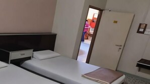 A hotel room with two single beds, a desk, a chair, and a wardrobe. - Marina Hotel Kemaman (Chukai)