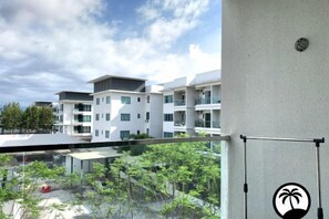 A modern building with multiple balconies and a clear sky. - Paradise Suite at the Loft, Imago (Kota Kinabalu)