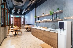 Eine moderne Küche mit integriertem Wasserspender, Holzschränken und einer Wand aus Backsteinen.