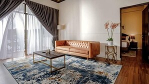 A modern living room with a sofa, coffee table, and a potted plant. - SpringHill Resort (Brinchang)