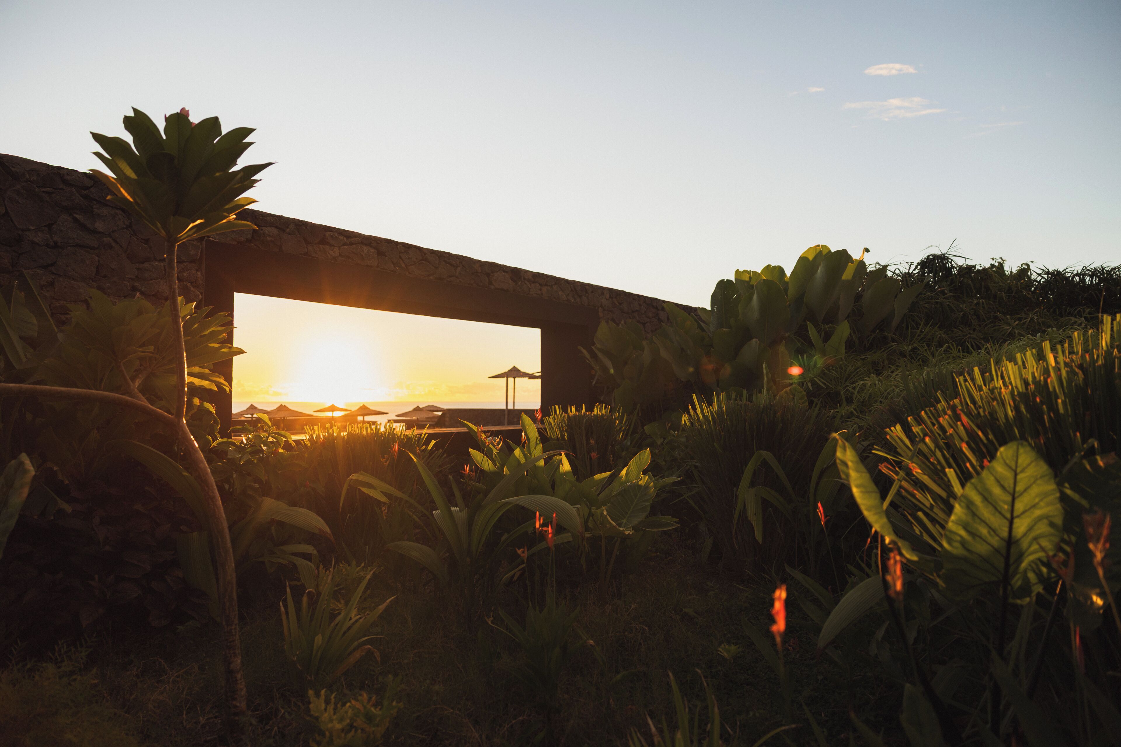 A stone structure with a view of the sunset.