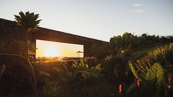 A stone structure with a view of the sunset.