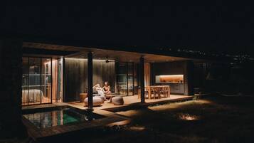 A modern house with a swimming pool, a dining area, and a kitchen.