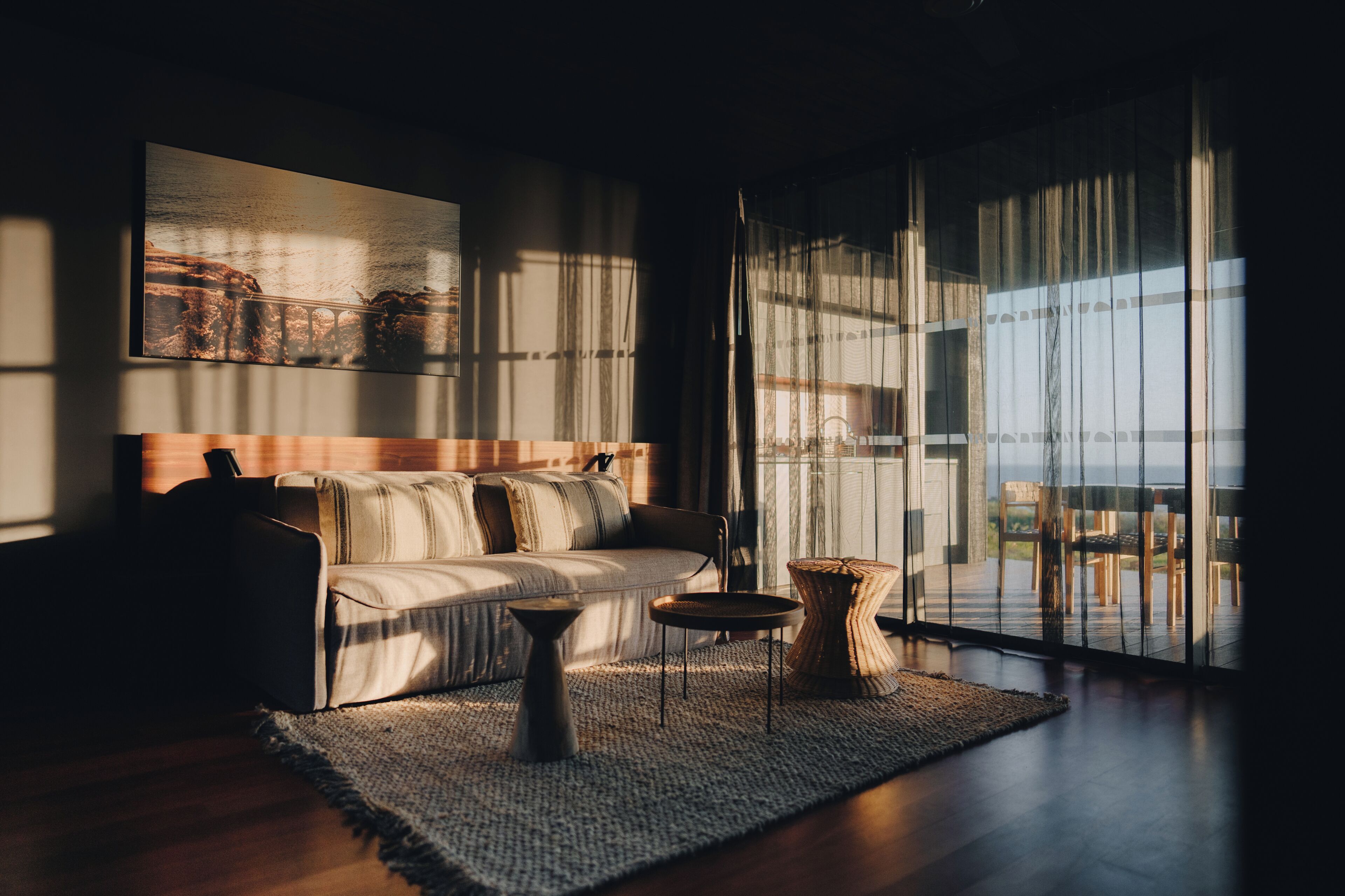 A modern living room with a sofa, a coffee table, and a rug.