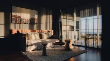 A modern living room with a sofa, a coffee table, and a rug.