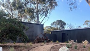 A wooden pathway leading to a building with a metal exterior.