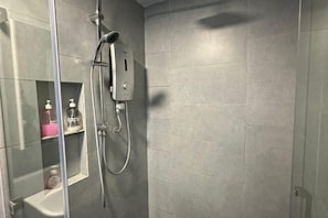 A modern bathroom with a glass shower enclosure, a handheld showerhead, and a control panel. - L Homestay Jesselton Quay (Near Gaya Street, Near Pier) (Kota Kinabalu)