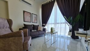 A modern living room with a sofa, armchair, and coffee table.