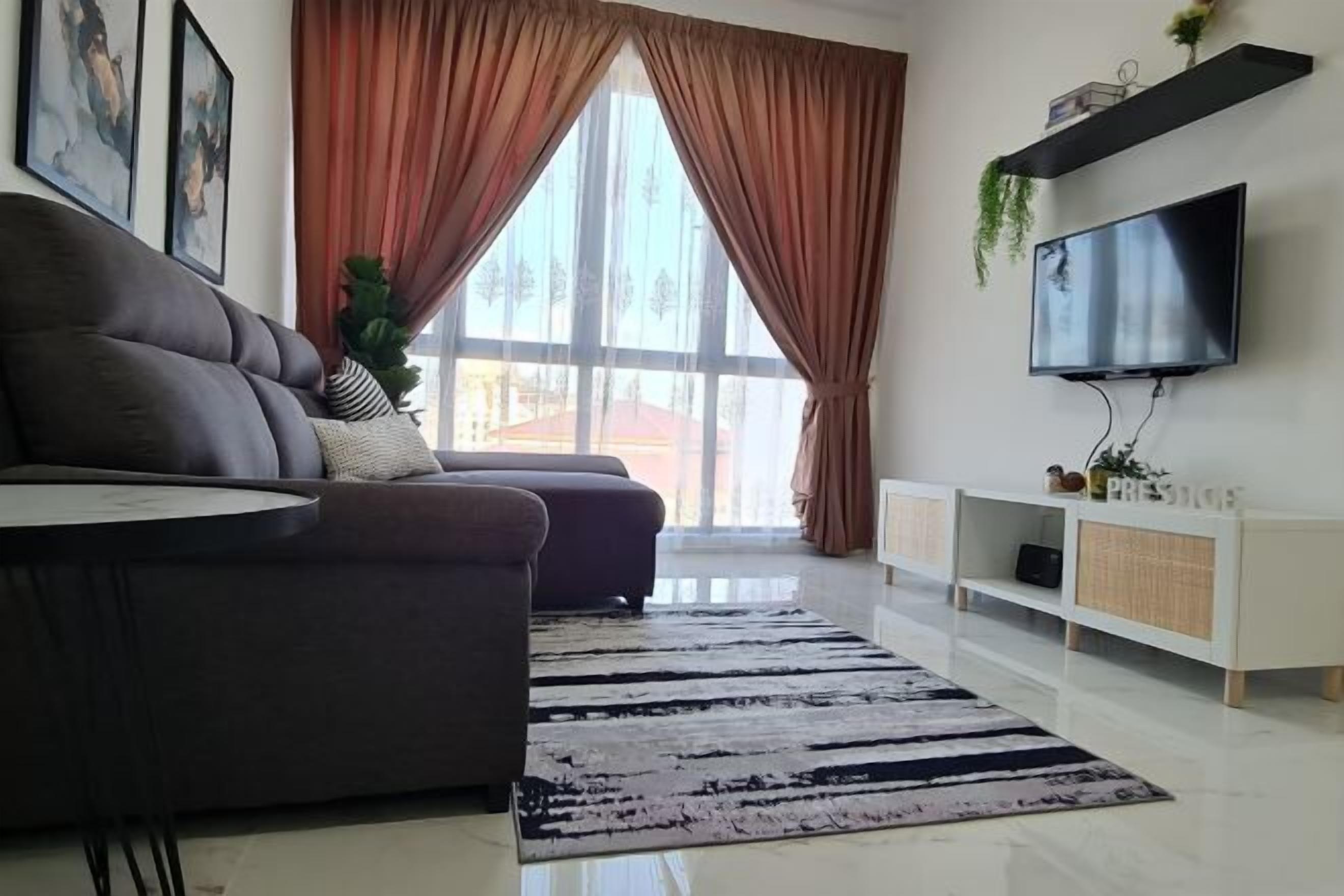 A modern living room with a sofa, a flat-screen TV, a large window with curtains, and a white console table.