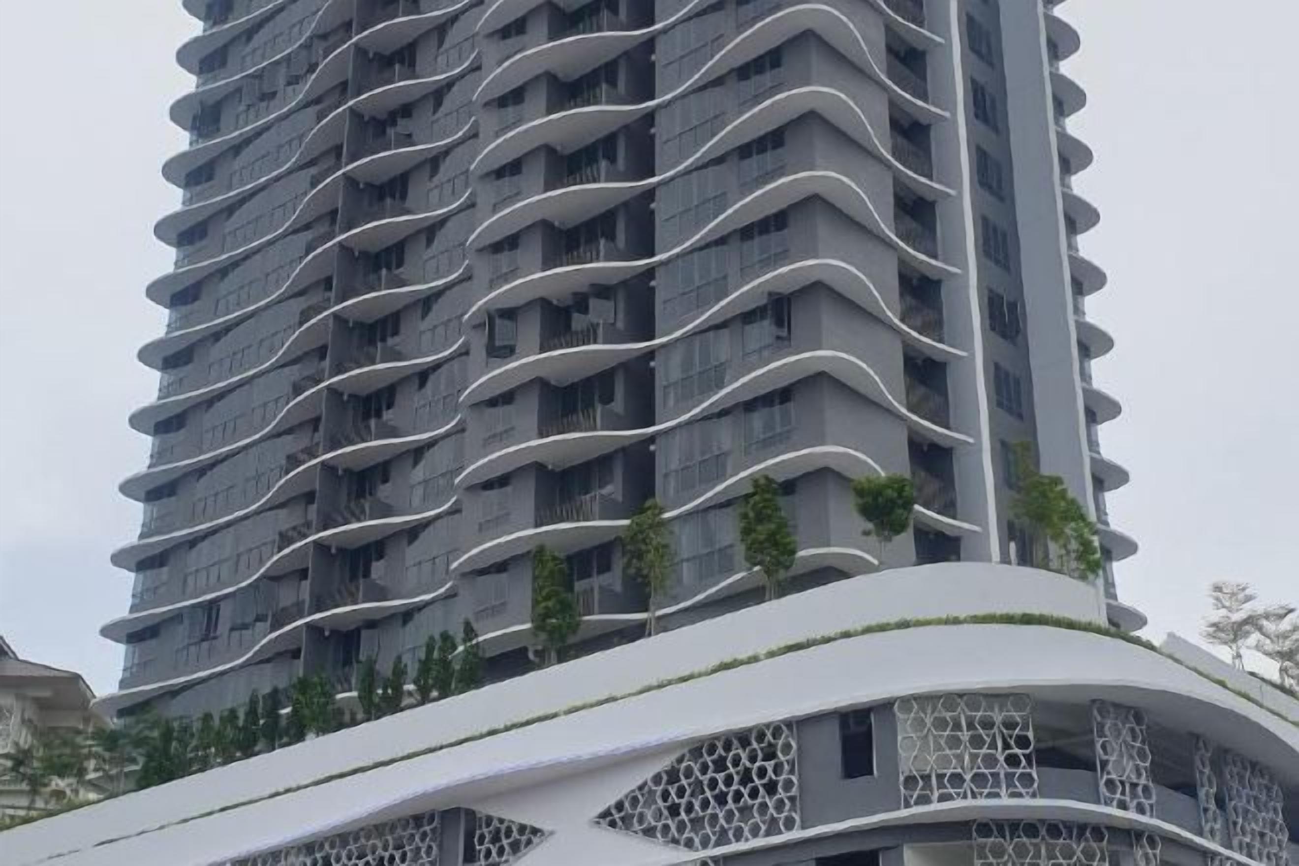 A high-rise building with a curved facade and balconies.