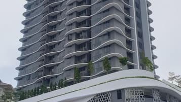 A high-rise building with a curved facade and balconies.