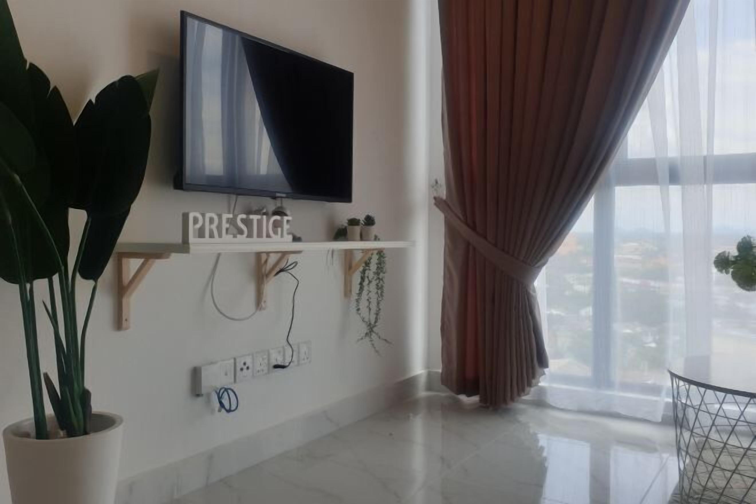 A modern living room with a flat-screen TV mounted on the wall, a potted plant, a shelf with decorative items, and a large window with curtains.