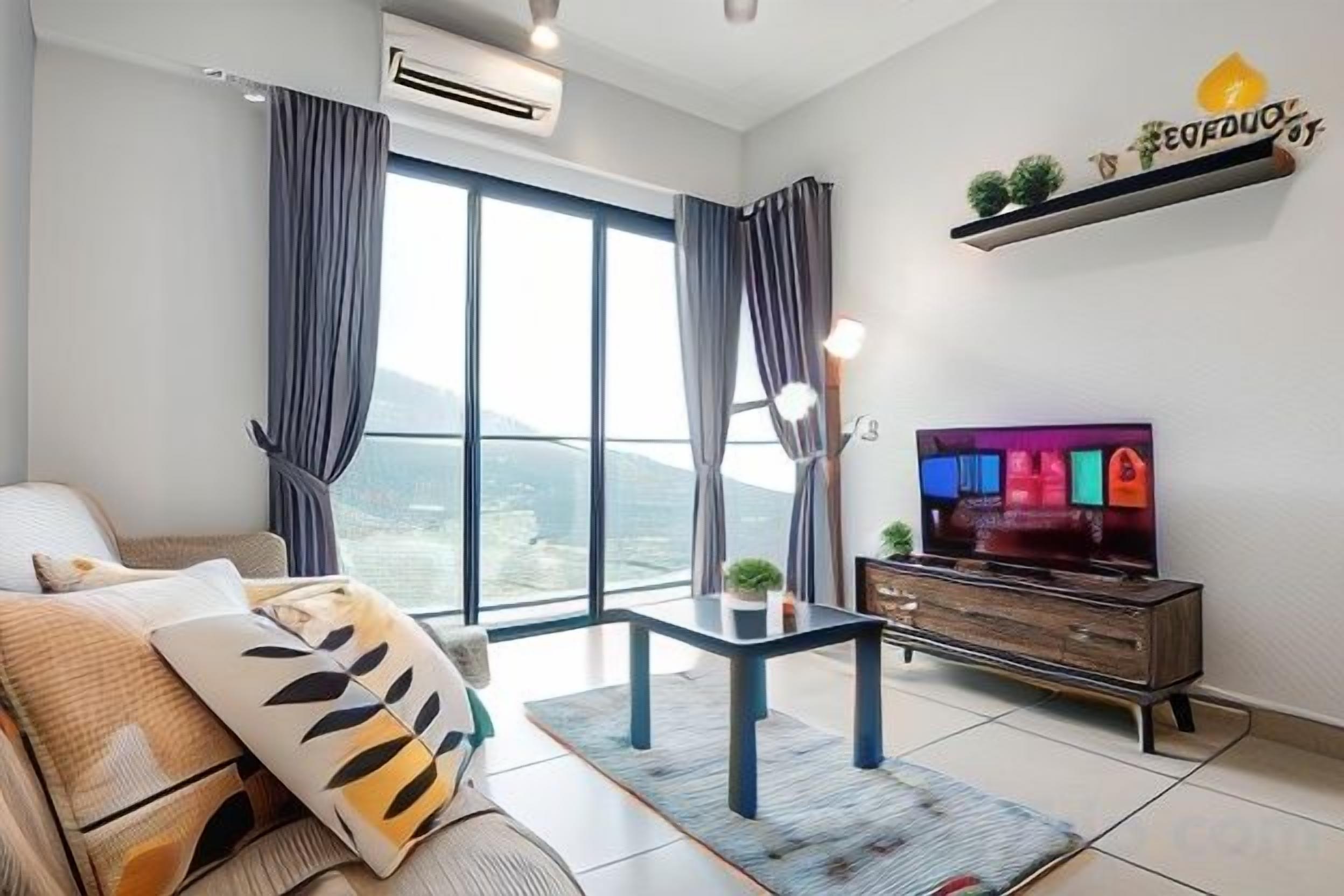 A modern living room with a sofa, a TV, and a view of the outdoors.