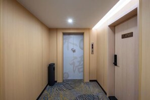 A hotel hallway with a door marked '3701' and a trash bin to the left. - Yimi Hotel (Provincial Library Branch near Hainan Institute of Business and Technology) (Haikou)