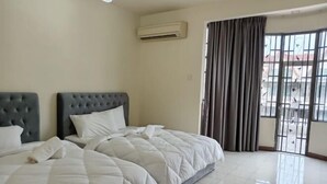 A hotel room with a large bed, an air conditioning unit, and a view through a window with curtains. - BUTTERWORTH RAJA UDA RAYA HOMESTAY (Butterworth)