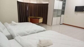 A hotel room with two beds, a desk, a chair, a TV, and a wardrobe. - BUTTERWORTH RAJA UDA RAYA HOMESTAY (Butterworth)