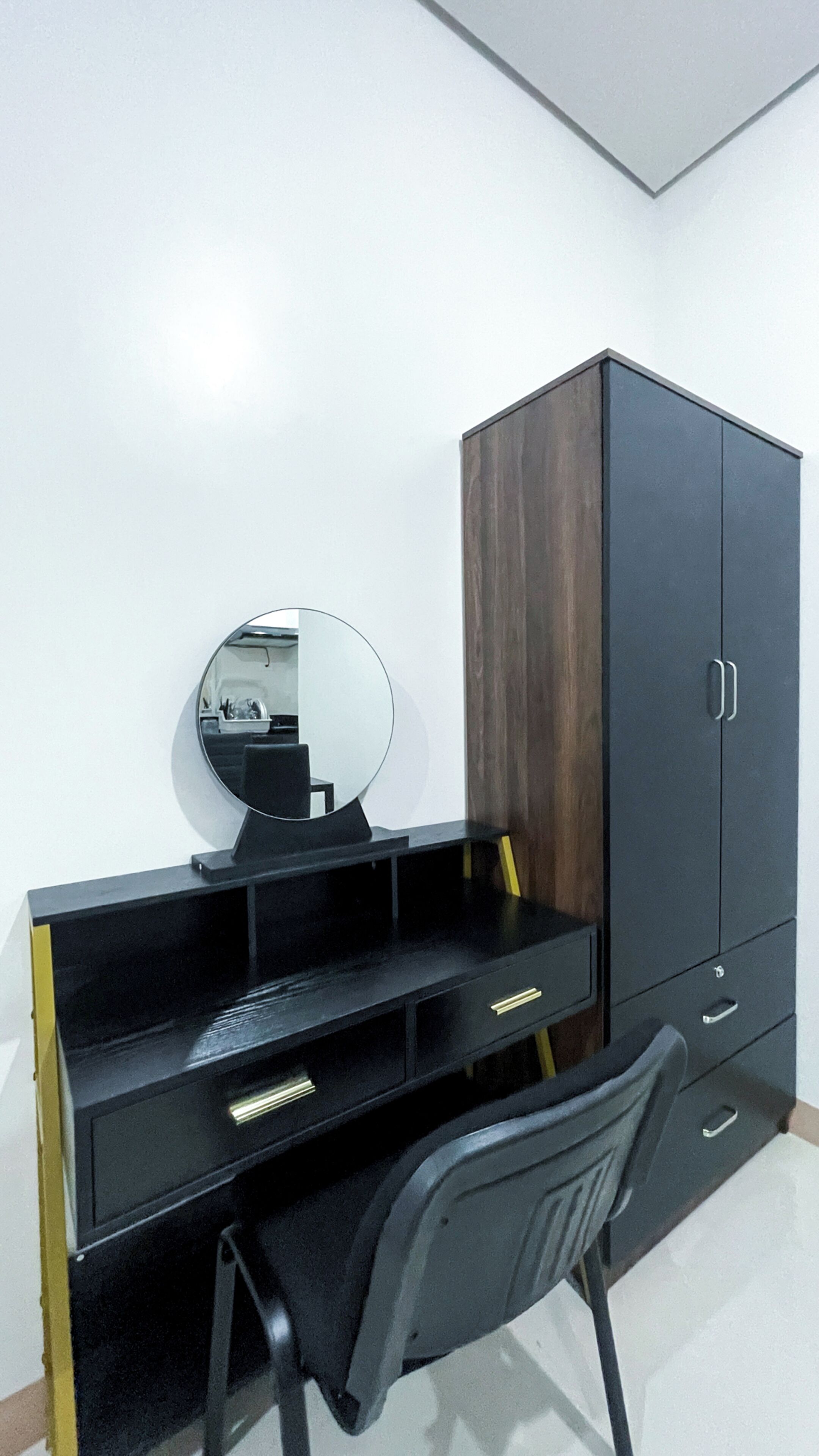 A study area with a desk, chair, and a wardrobe.