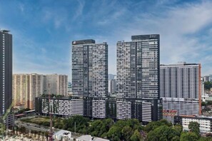 A high-rise residential building complex with multiple apartment buildings, surrounded by greenery and a clear sky. - Urban Suites by Stellar ALV (Jelutong)
