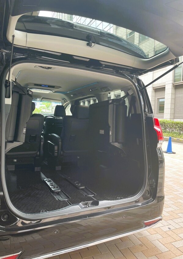 A vehicle's interior with a rear view, including a visible license plate, a rearview mirror, and a rear window.