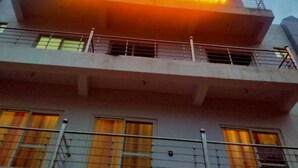 A hotel sign with the name "HOTEL NIRVANAM" illuminated. - Hotel Nirvanam (Chamoli)