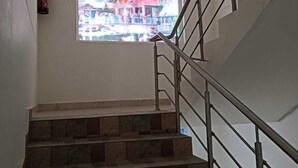 A staircase with metal railings and stone steps. - Hotel Nirvanam (Chamoli)