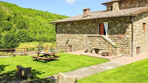 A stone house with a tiled roof, a wooden deck, and a picnic table. - Stunning  villa for 12 guests with WIFI, private pool, TV, balcony, pets allowed and panoramic v... (Greve In Chianti)