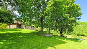 A stone house with a tiled roof, surrounded by lush green grass and trees. - Stunning  villa for 12 guests with WIFI, private pool, TV, balcony, pets allowed and panoramic v... (Greve In Chianti)