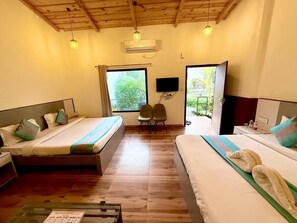 A hotel room with two beds, a TV, and a window. - Shelton Blu Resort  (Ramnagar)