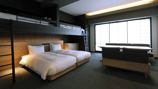 A modern hotel room with a bunk bed, a desk, and a sofa. - KOKO HOTEL Residence Kyoto Nijo Castle (Kyoto)