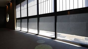 A spacious hallway with large windows and a circular skylight.