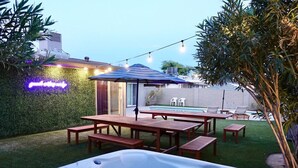 A backyard with a hot tub, wooden picnic tables, and a pool. - Great 4 Groups, Near Everything! (Phoenix)