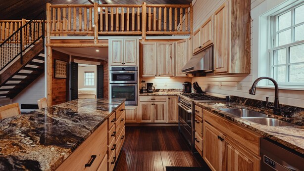 A spacious kitchen with wooden cabinets, a granite countertop, and a built-in oven.