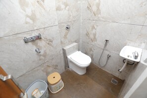 Standard Triple Room, City View | Bathroom | Shower, hair dryer, slippers, towels - Hotel Garima (Ujjain)