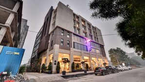 A hotel with a modern design, featuring a prominent 'Hotel' sign and a well-lit entrance. - Click Collection Amritsar (Amritsar)