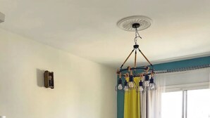 A living room with a sofa, coffee table, and a dining area with a table and chairs. - Charming condo in pleasant Rabat with WiFi (Temara)