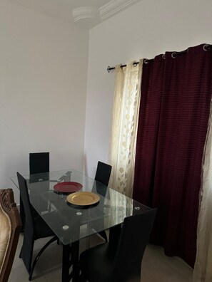 Enjoy meals in this dining area with a glass table and comfortable seating for two.